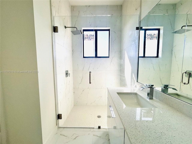 bathroom with marble finish floor, vanity, and a marble finish shower