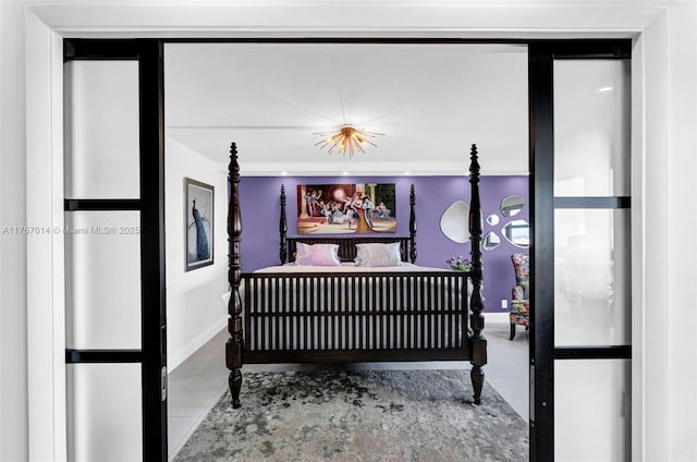 tiled bedroom featuring baseboards