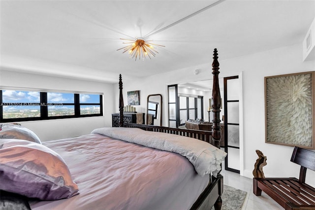 bedroom featuring an inviting chandelier, multiple windows, and light tile patterned floors