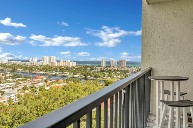 balcony featuring a water view and a view of city