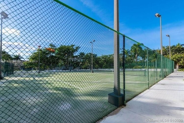 view of tennis court with fence