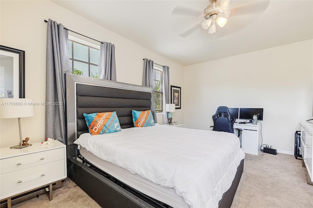 bedroom featuring a ceiling fan, light carpet, and baseboards