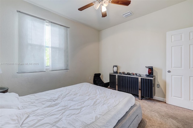 carpeted bedroom with ceiling fan, visible vents, and baseboards