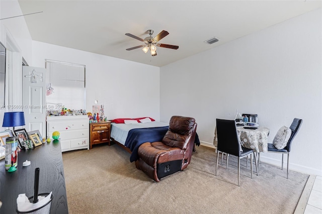 bedroom featuring baseboards, carpet flooring, visible vents, and a ceiling fan