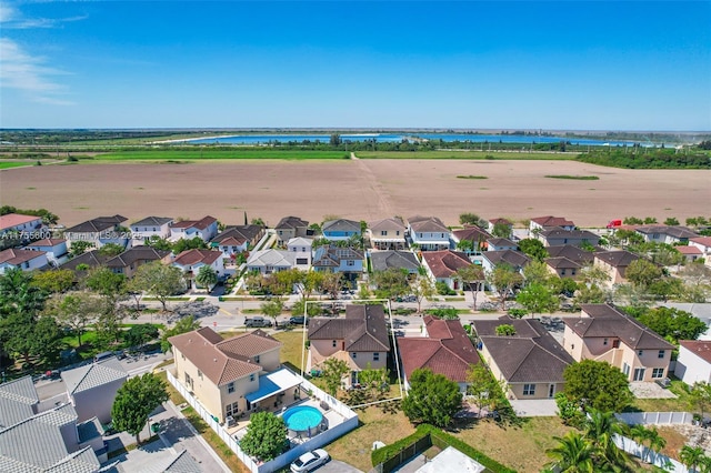 bird's eye view featuring a water view and a residential view