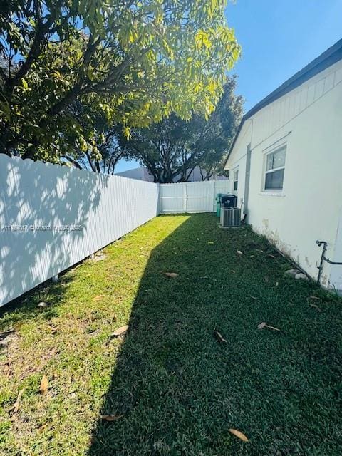 view of yard with cooling unit and a fenced backyard