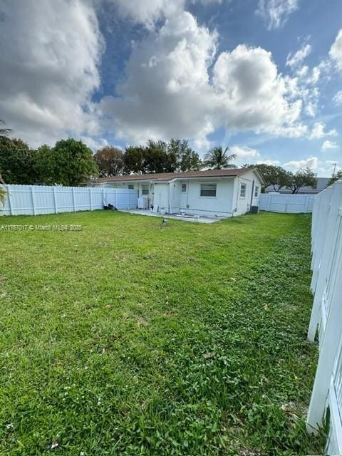 view of yard with a fenced backyard