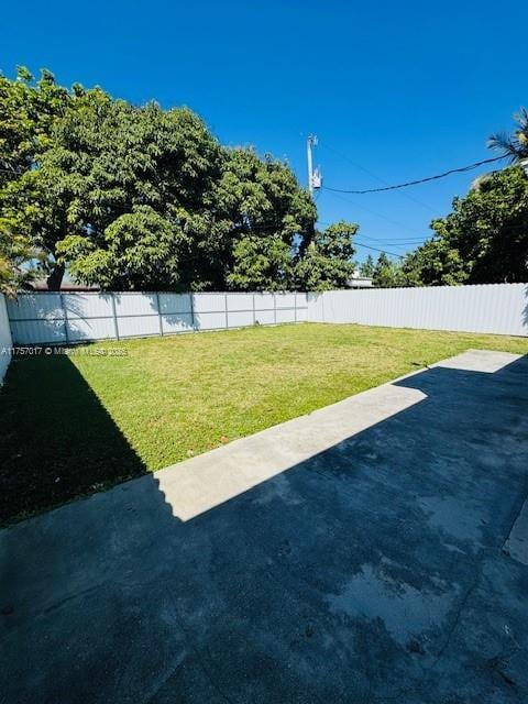 view of yard with a fenced backyard and a patio