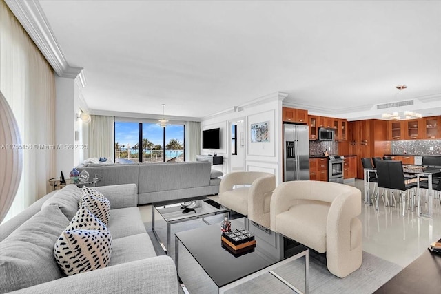 living area featuring an inviting chandelier, visible vents, and crown molding