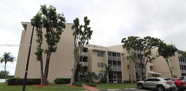 view of building exterior featuring uncovered parking