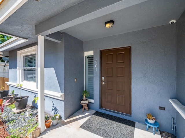 entrance to property with stucco siding