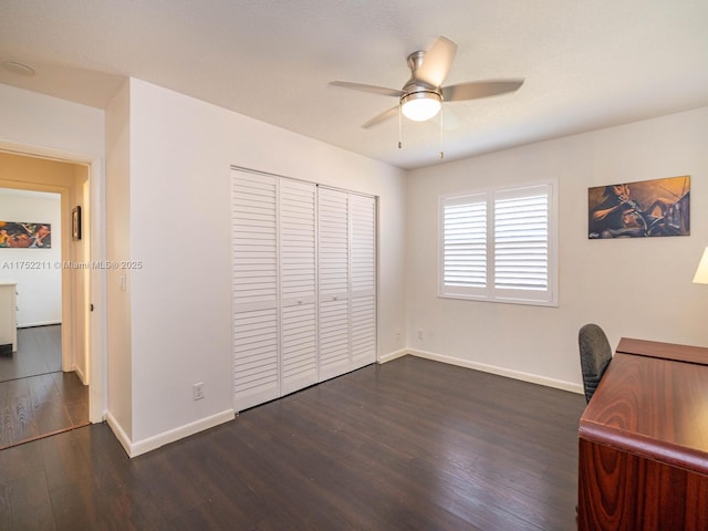 office with a ceiling fan, baseboards, and dark wood-style flooring