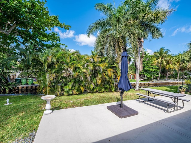 surrounding community with a patio area and a lawn