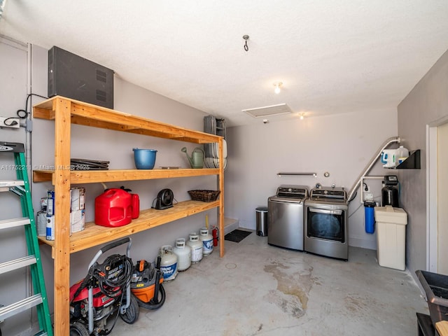 interior space with attic access and washing machine and clothes dryer