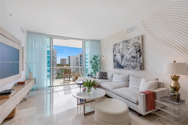 living area featuring visible vents, a view of city, and floor to ceiling windows