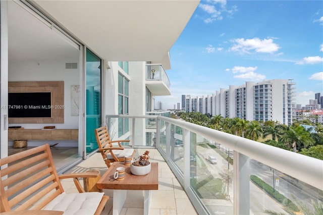 balcony featuring visible vents and a city view