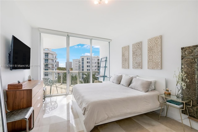 bedroom featuring access to exterior and floor to ceiling windows