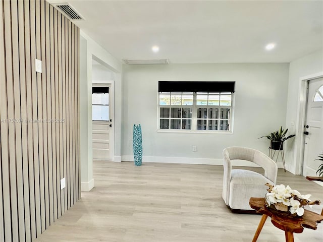 sitting room with a wealth of natural light, light wood-style flooring, baseboards, and recessed lighting