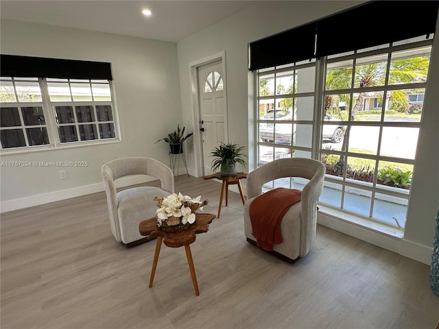 sitting room with recessed lighting, light wood-style flooring, and baseboards