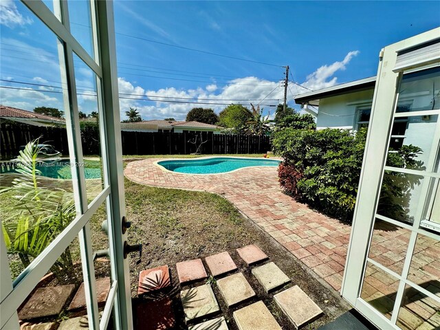 view of pool featuring a patio area, a fenced backyard, and a fenced in pool