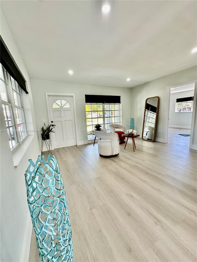 interior space featuring light wood-style floors, baseboards, and recessed lighting