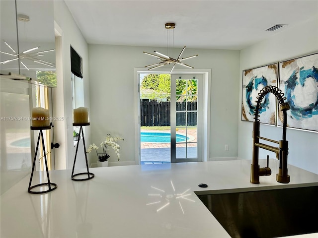 interior space featuring visible vents and an inviting chandelier