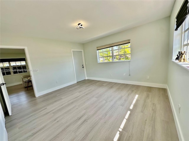 unfurnished bedroom featuring light wood-style flooring and baseboards