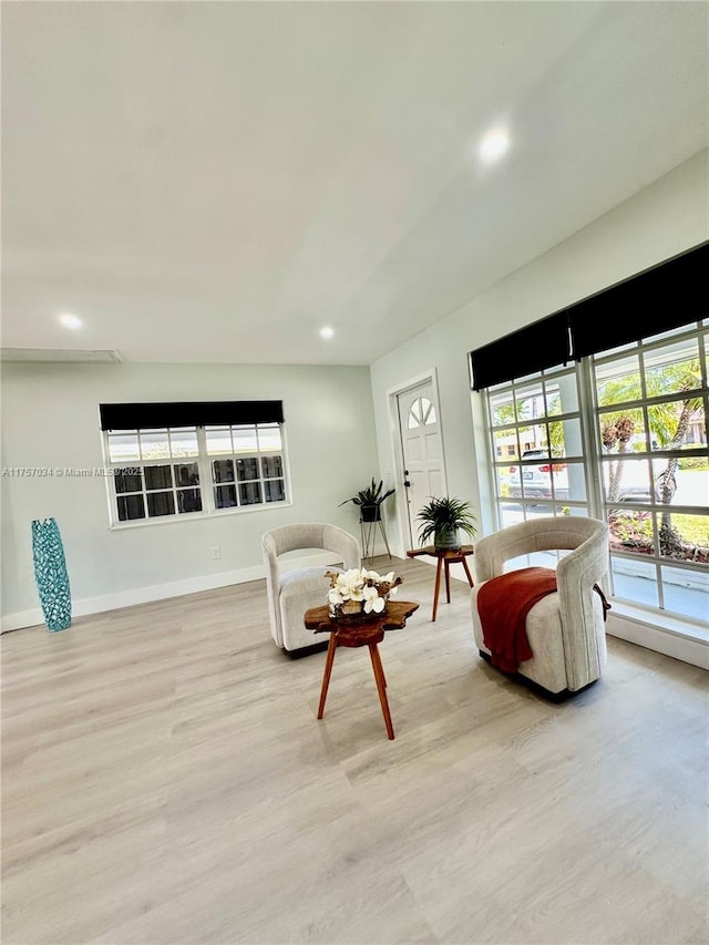 living room featuring recessed lighting, light wood-style flooring, and baseboards