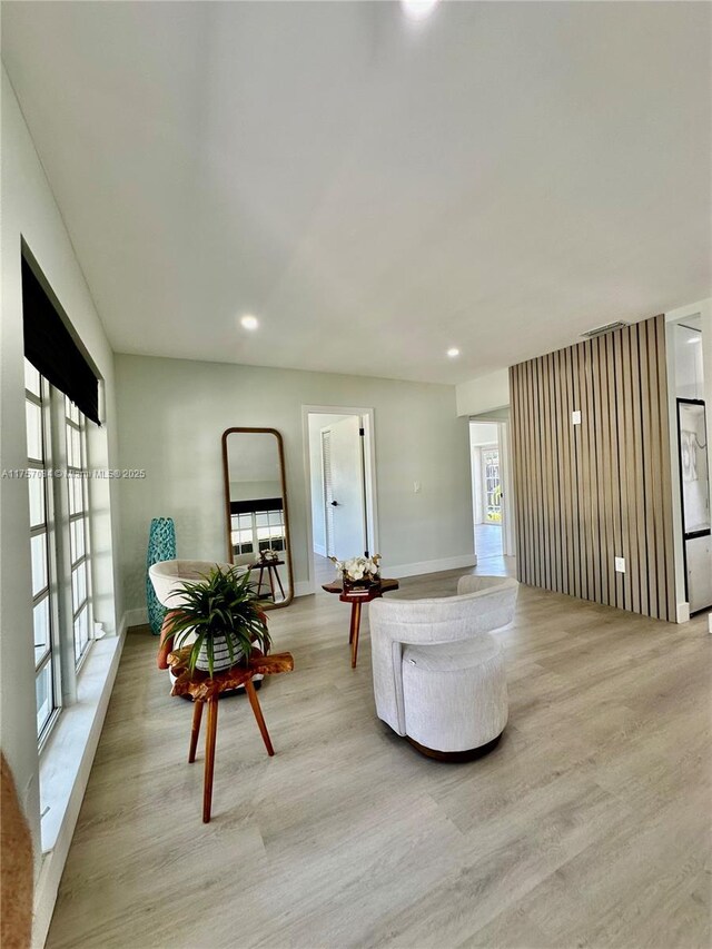 sitting room featuring light wood-style floors, baseboards, visible vents, and recessed lighting