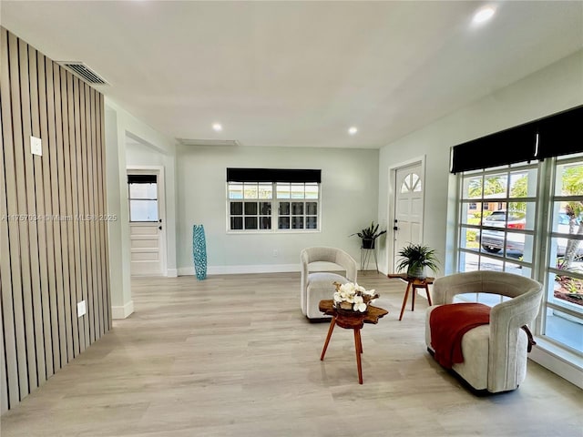 sitting room with recessed lighting, baseboards, visible vents, and light wood finished floors