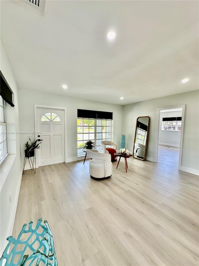 interior space featuring light wood-type flooring, visible vents, baseboards, and recessed lighting