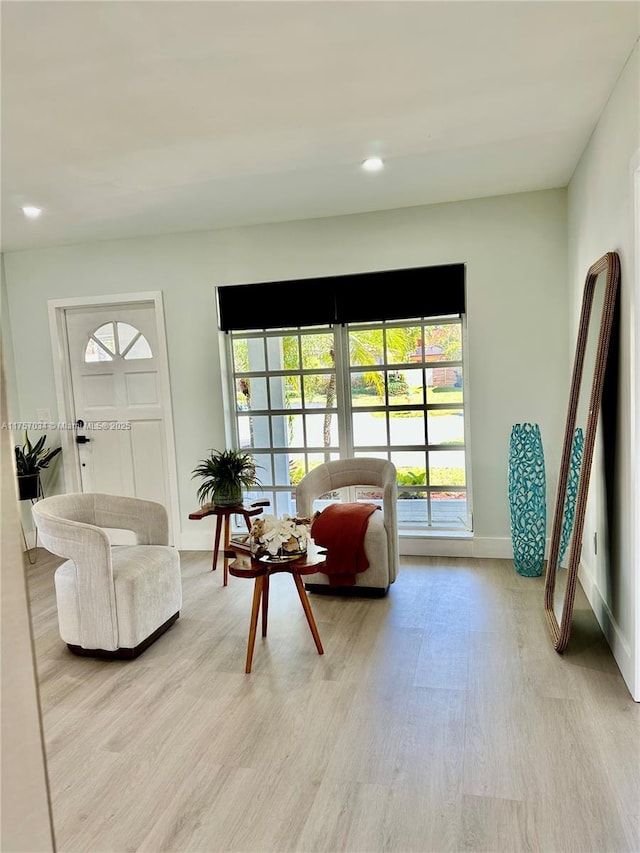 sitting room with light wood-style floors, baseboards, and recessed lighting