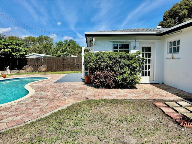 view of swimming pool featuring a patio, fence, and a fenced in pool