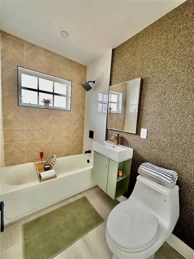 bathroom with toilet, shower / washtub combination, and vanity