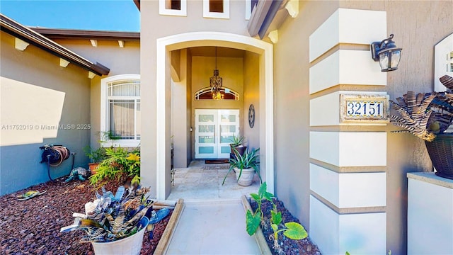 entrance to property with stucco siding