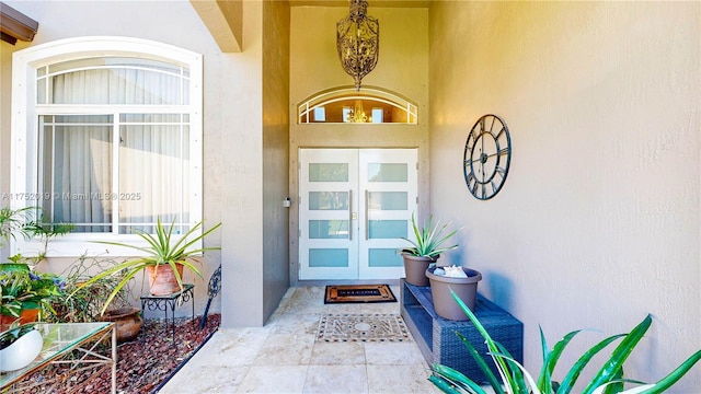 doorway to property featuring french doors and stucco siding