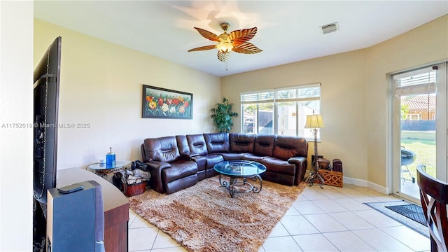 living area with light tile patterned floors, baseboards, visible vents, and a ceiling fan