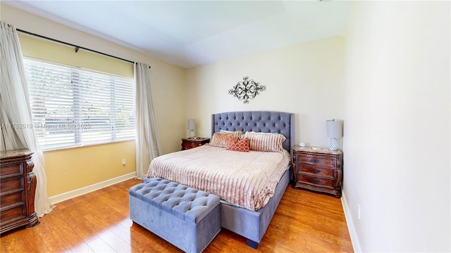 bedroom featuring light wood-style flooring and baseboards