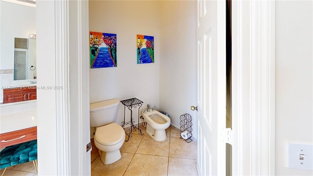 full bath featuring tile patterned flooring, toilet, vanity, a shower stall, and a bidet