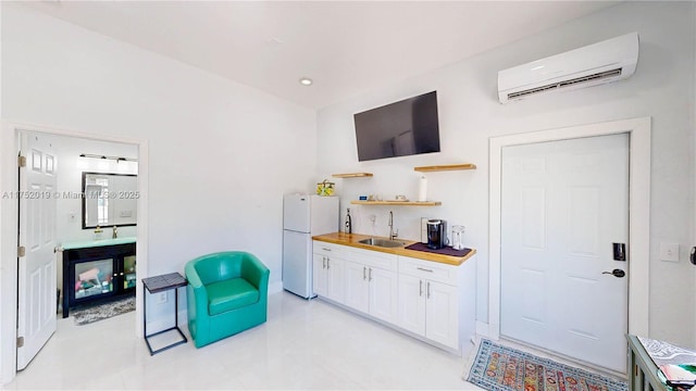 sitting room featuring an AC wall unit