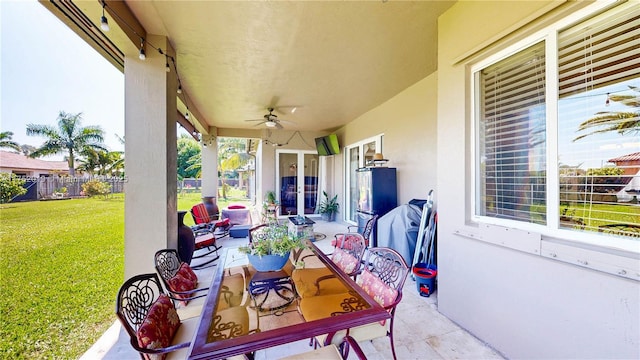 view of patio / terrace with a ceiling fan, outdoor dining space, and fence