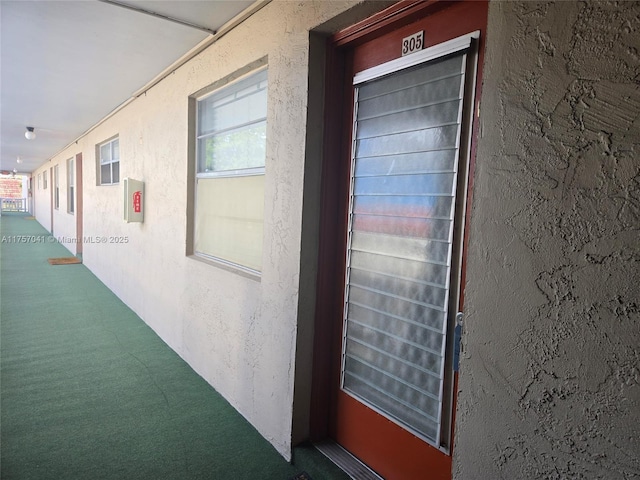 doorway to property with stucco siding