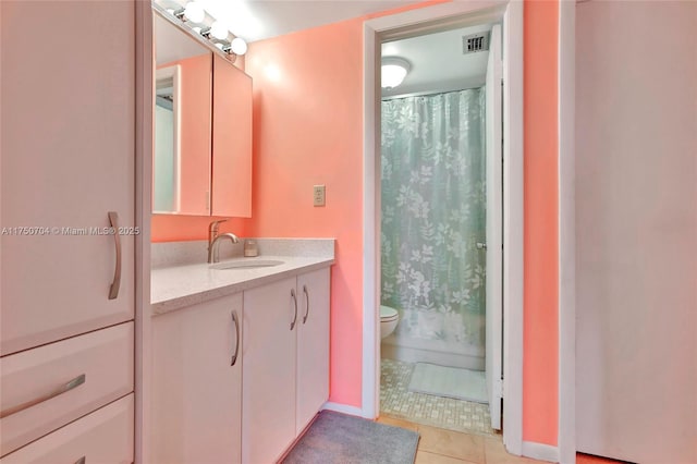 bathroom with visible vents, a shower with shower curtain, toilet, tile patterned flooring, and vanity