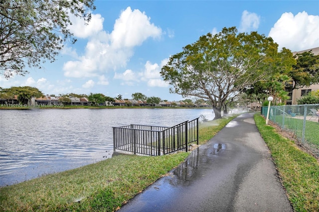 dock area featuring a water view and fence