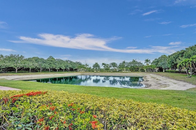 view of home's community featuring a water view and a yard