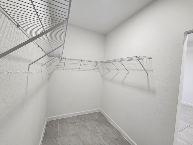 spacious closet featuring tile patterned flooring