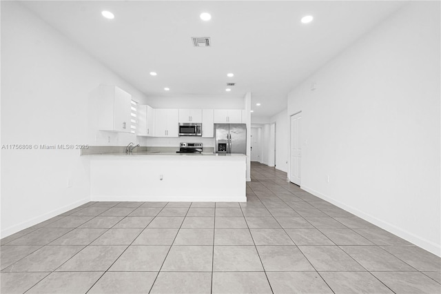12735 SW 211th St, Miami, FL 33177 - kitchen featuring stainless steel appliances, a peninsula, recessed lighting, baseboards, and light countertops