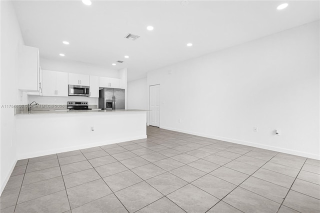 12735 SW 211th St, Miami, FL 33177 - kitchen featuring stainless steel appliances, a peninsula, recessed lighting, light countertops, and white cabinetry