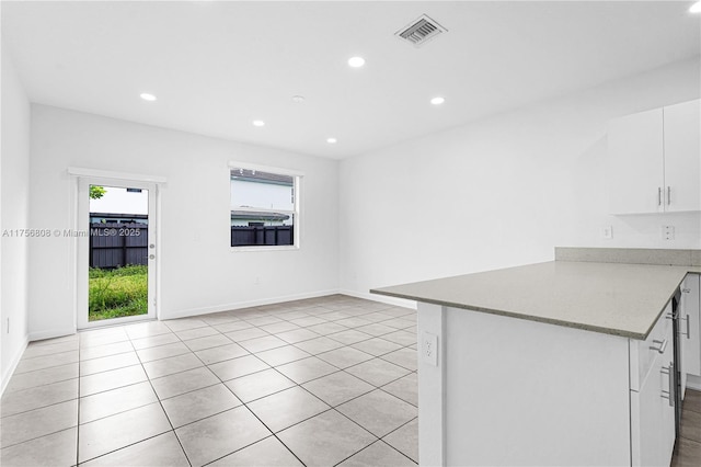 12735 SW 211th St, Miami, FL 33177 - kitchen featuring healthy amount of natural light, recessed lighting, white cabinets, light tile patterned floors, and baseboards