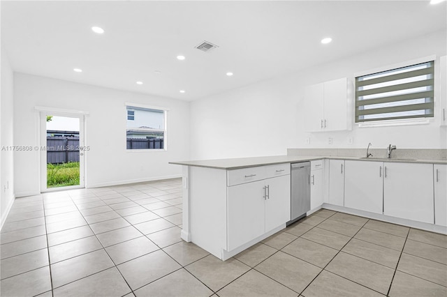 12735 SW 211th St, Miami, FL 33177 - kitchen with dishwasher, a sink, a peninsula, light tile patterned floors, and white cabinetry